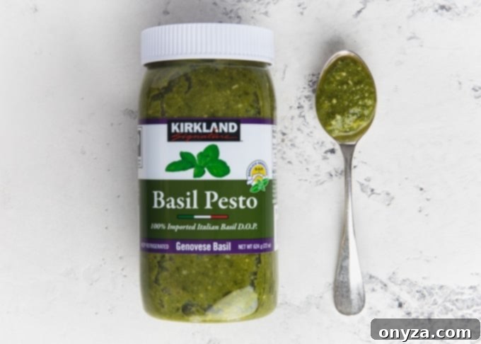 My Top 10 Costco Grocery Staples 9 Jar of Kirkland Signature basil pesto next to a spoonful of pesto, made with Genovese basil