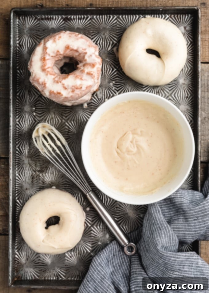 doughnuts dipped in brown butter blaze on a vintage baking tin