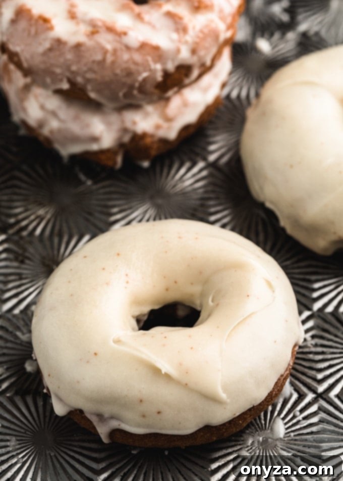 closeup of pumpkin doughnuts dipped in brown butter glaze
