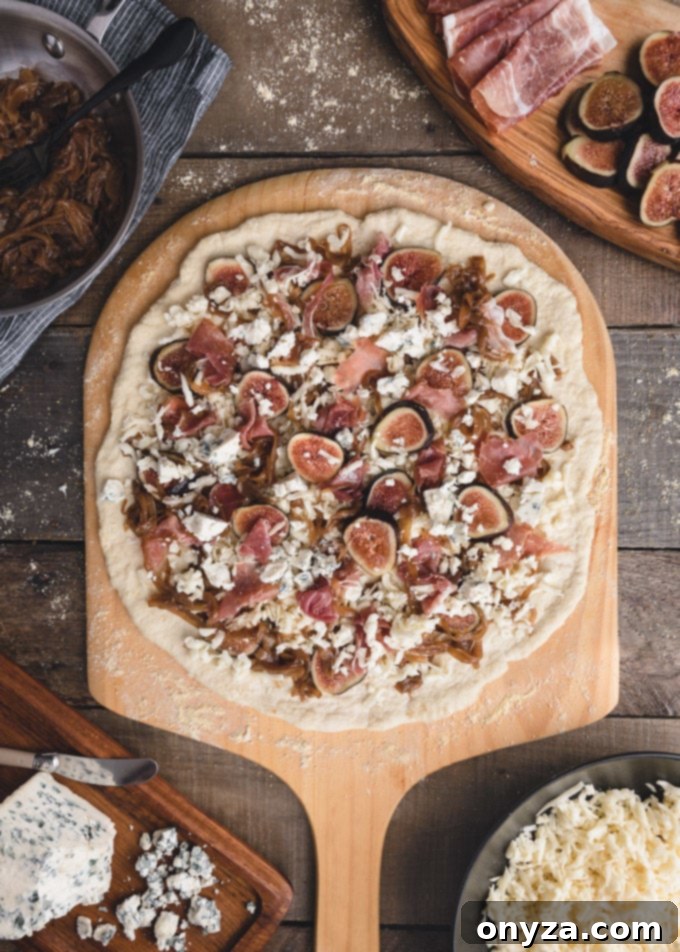 unbaked fig pizza on a wood paddle