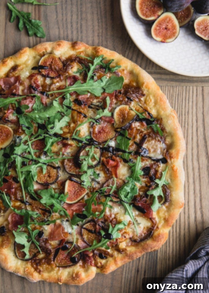 overhead of a baked fig pizza on a pizza peel