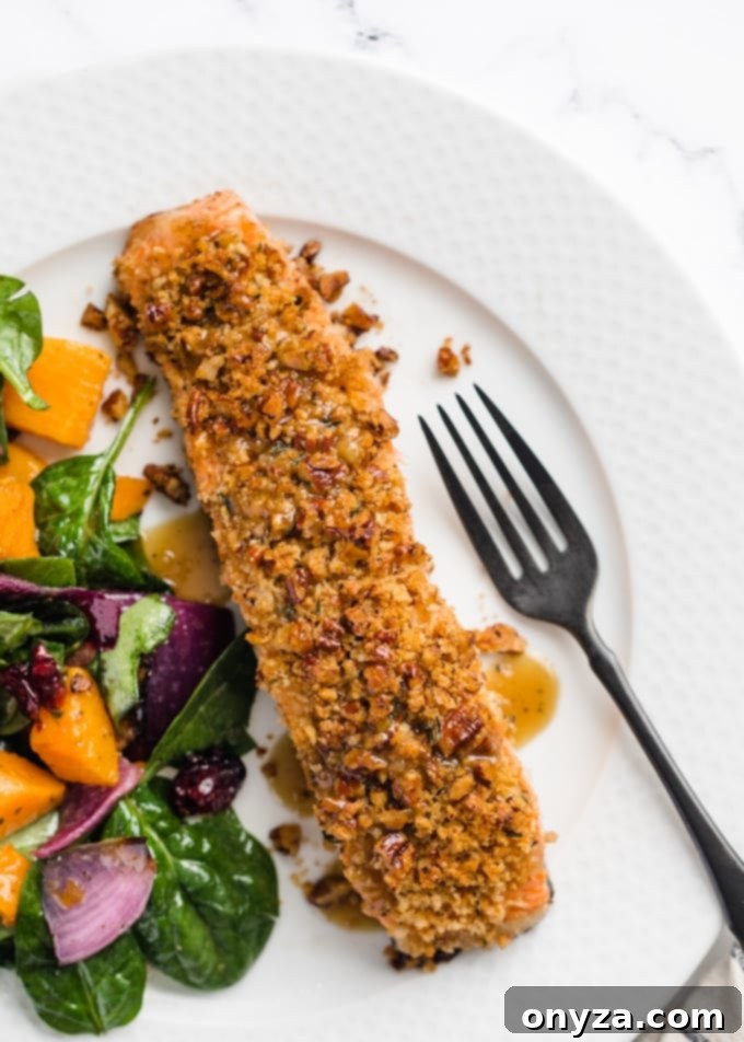 overhead view of pecan crusted salmon plated on a French white plate