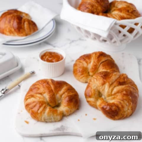 Golden-brown, flaky frozen croissants, ready for baking, promising a taste of France.