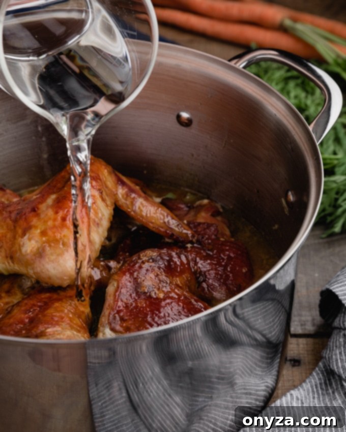 A cook pouring water into a large stock pot containing roasted turkey parts and sautéed vegetables, ready for simmering.