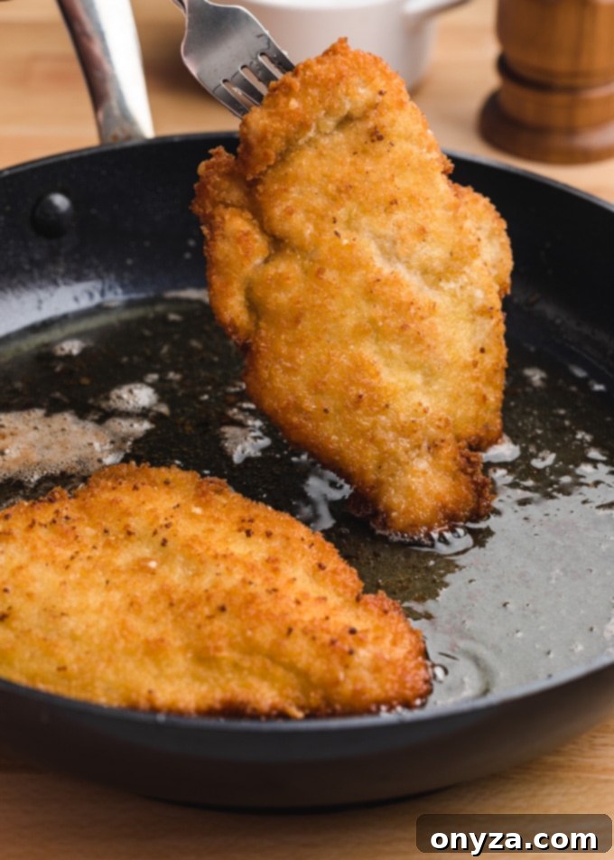 Stovetop and Air Fryer Chicken Milanese 5 breaded chicken cutlets fried in olive oil in a skillet