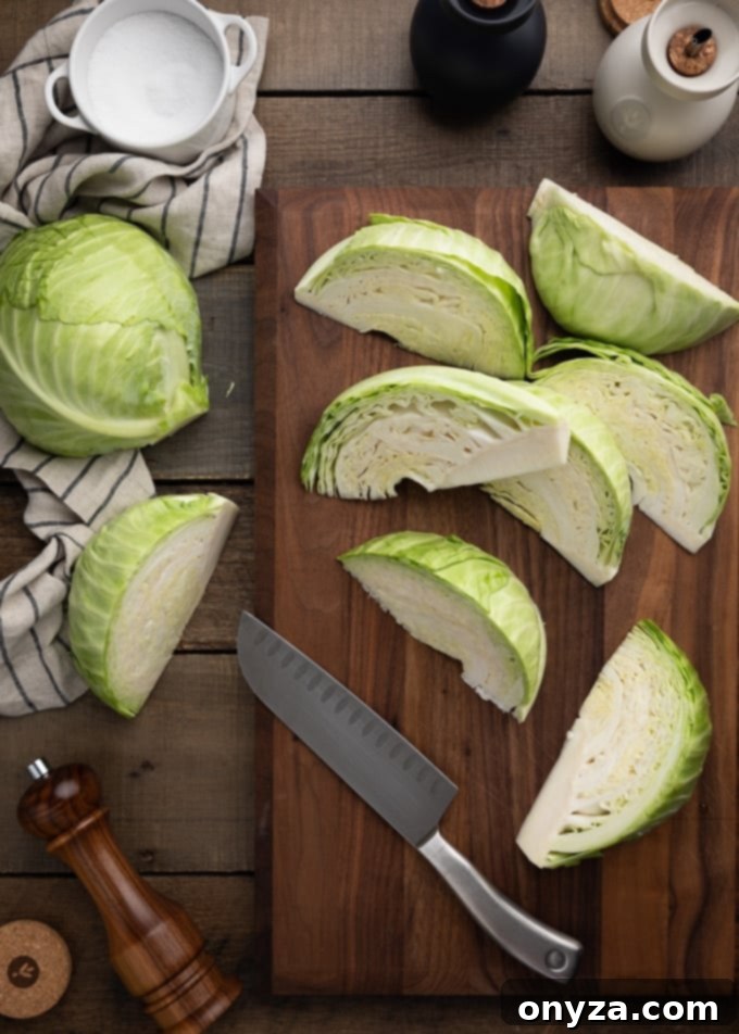 green cabbage wedges on a wood cutting board with a santoku knife