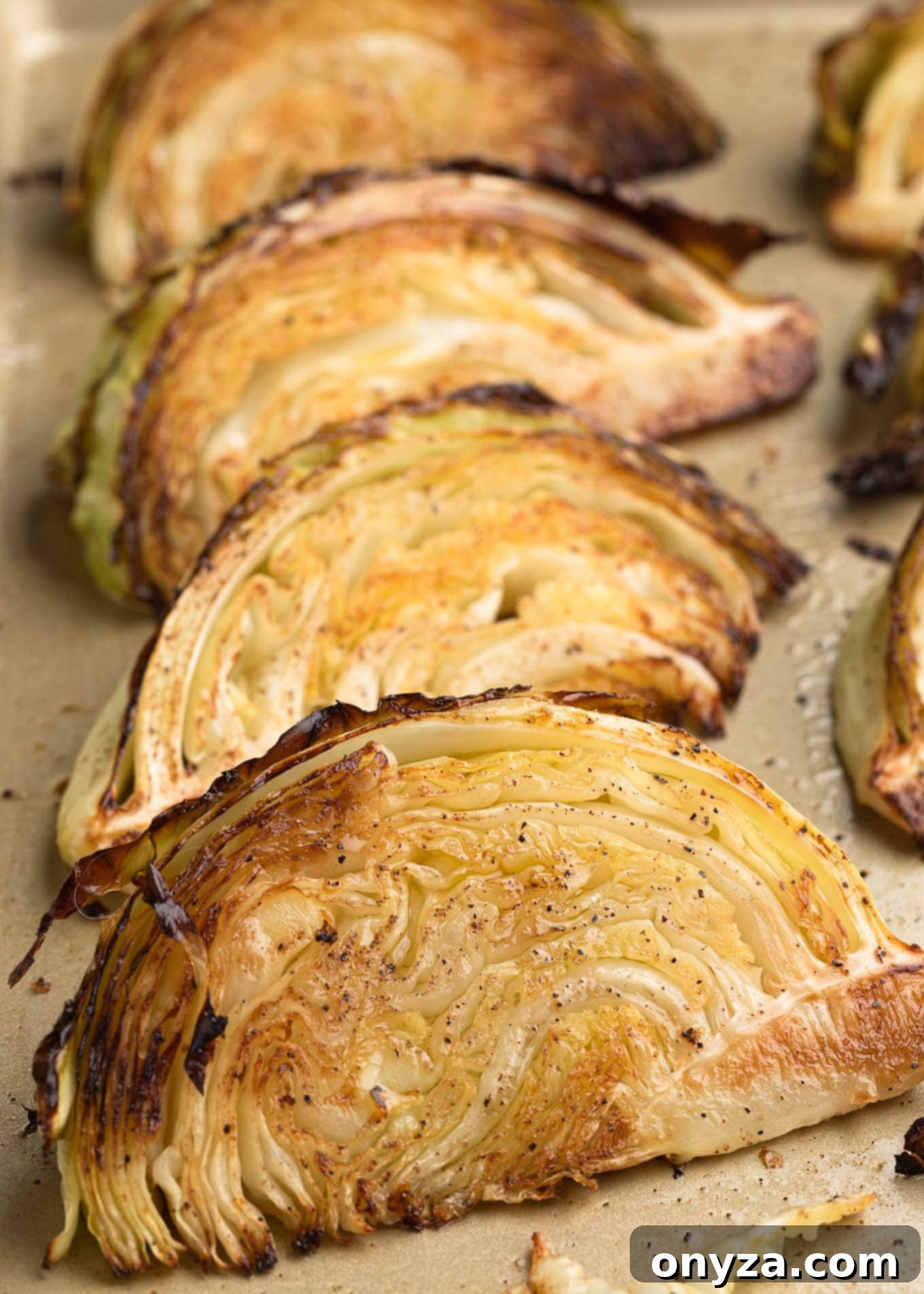 caramelized cabbage wedges on a baking sheet