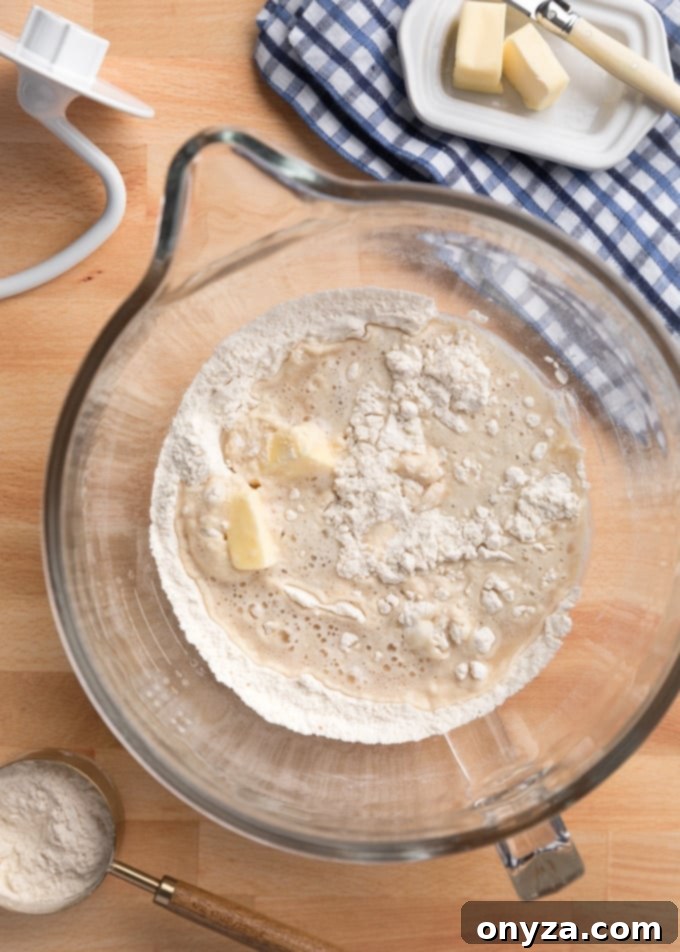unmixed ingredients for white bread in the bowl of a stand mixer