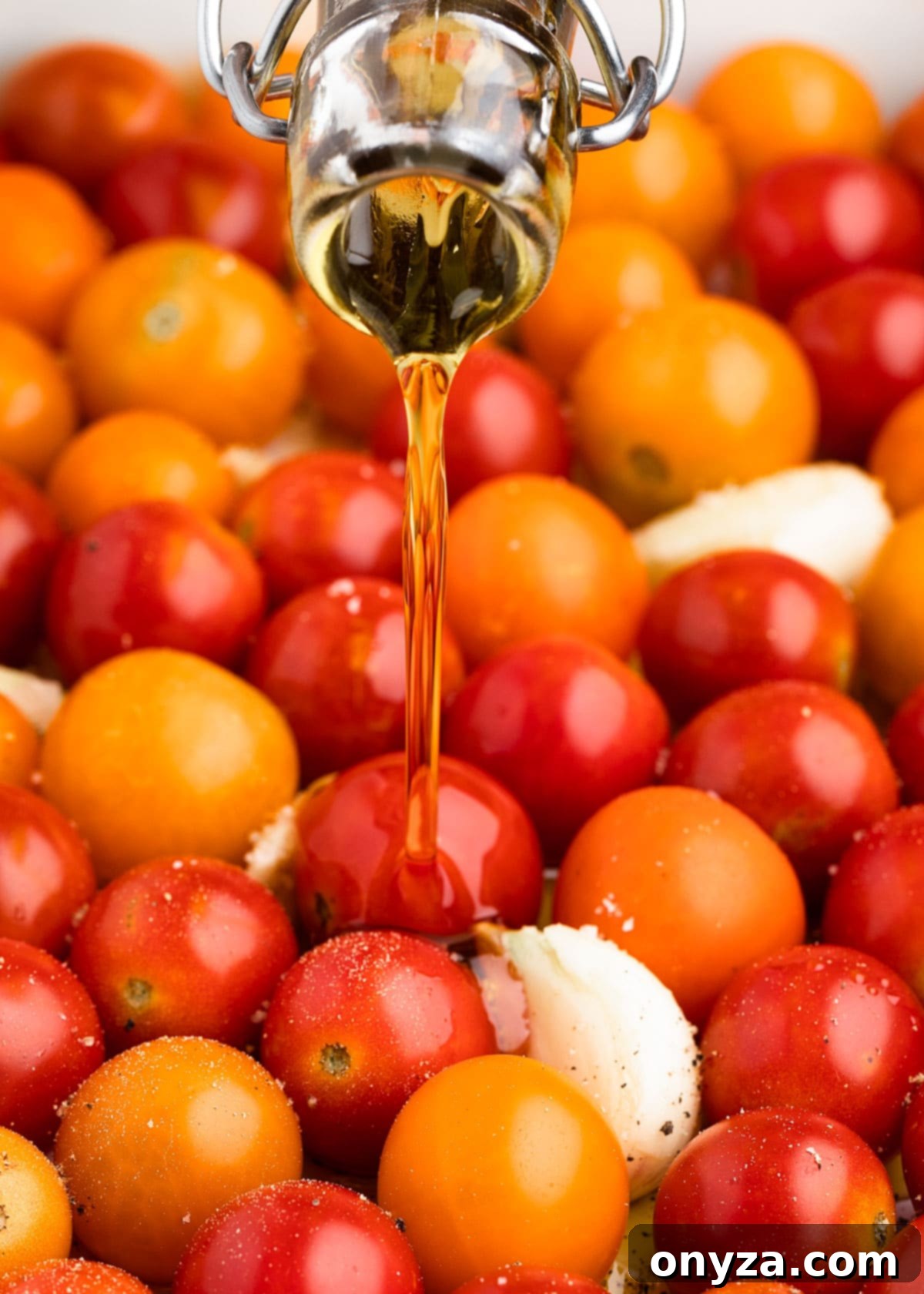 Garlic Herb Cherry Tomato Confit 4 pouring olive oil into a pan of cherry tomatoes and garlic cloves