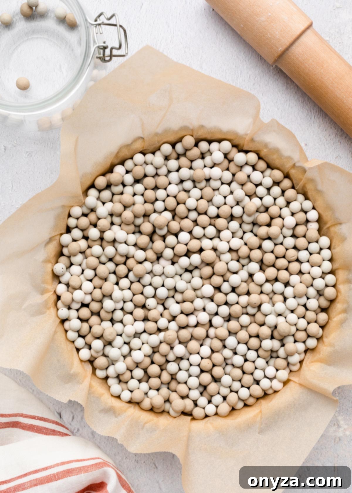 tart pan lined with parchment paper and filled with pie weights