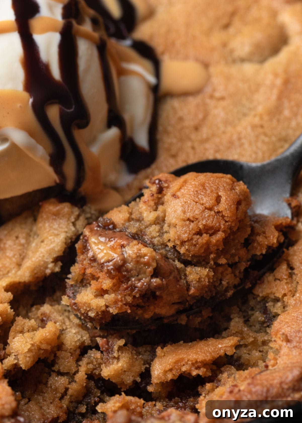 closeup of a spoonful of warm peanut butter skillet cookie