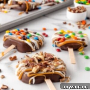 chocolate covered caramel apple slices decorated with candies and nuts on a white marble countertop