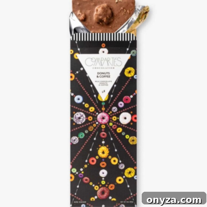 Compartés Donuts & Coffee Chocolate Bar, a gourmet milk chocolate bar with doughnut pieces and coffee grounds.