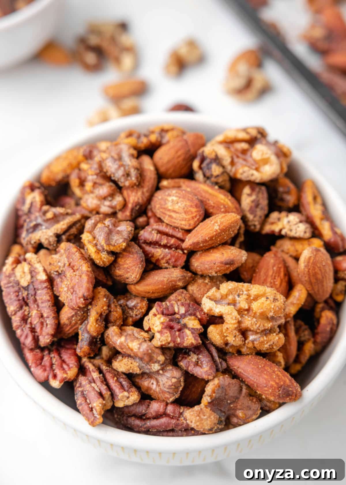 A beautifully presented bowl of Cajun spiced nut mix, artfully arranged on a marble board, ready for enjoyment.