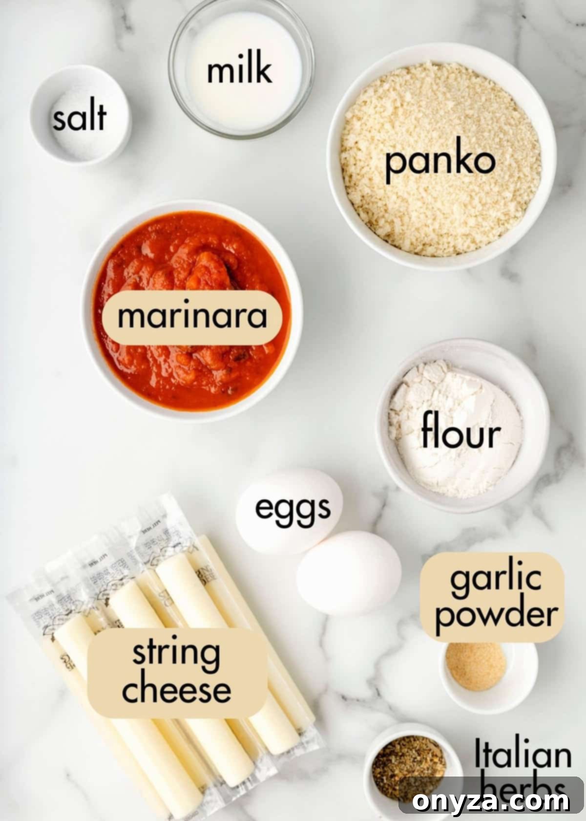 Overhead shot of all ingredients neatly arranged on a white marble background for making air fried mozzarella sticks.