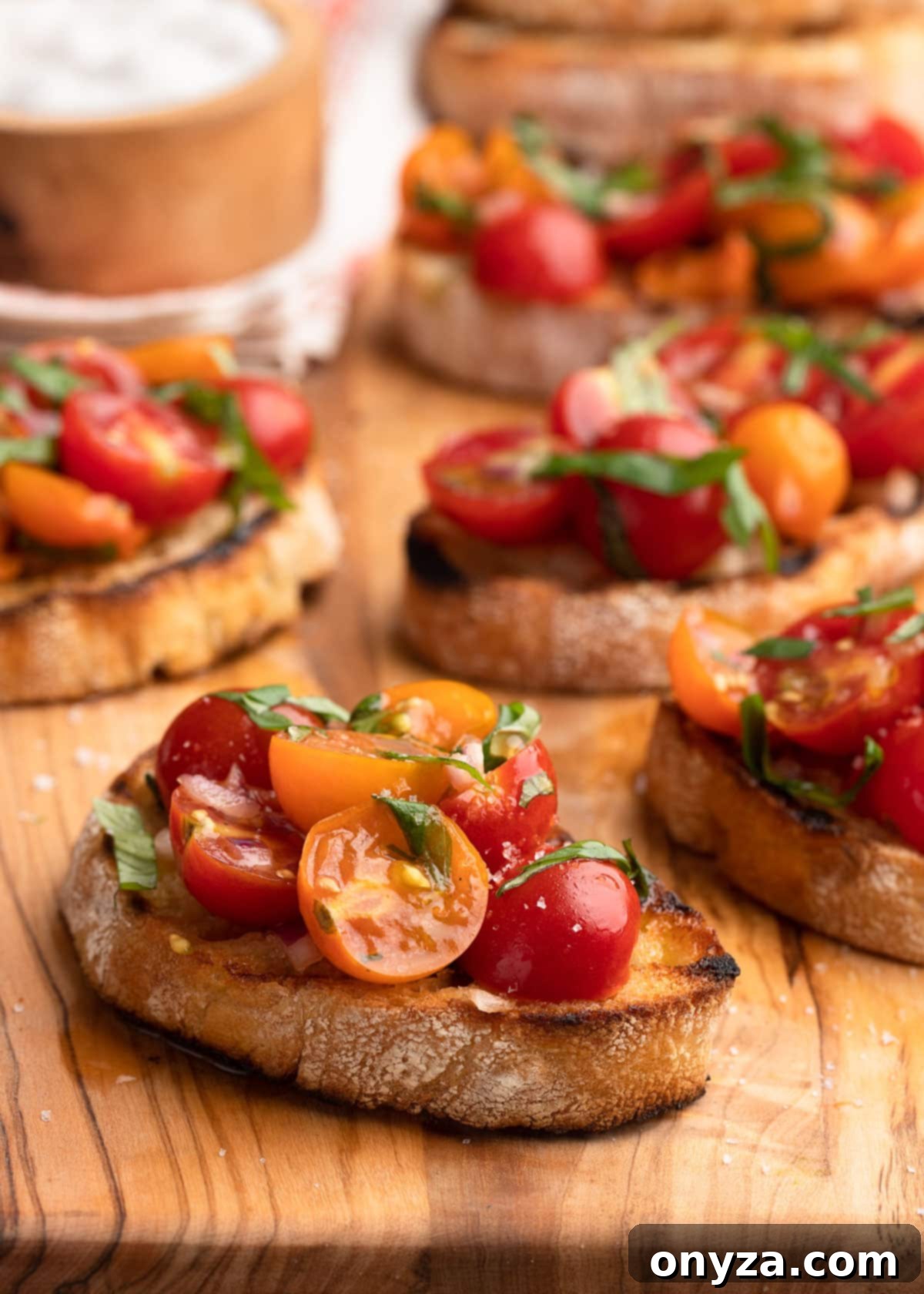 Fresh Cherry Tomato Bruschetta 2 Cherry Tomato Bruschetta on an olivewood serving board.