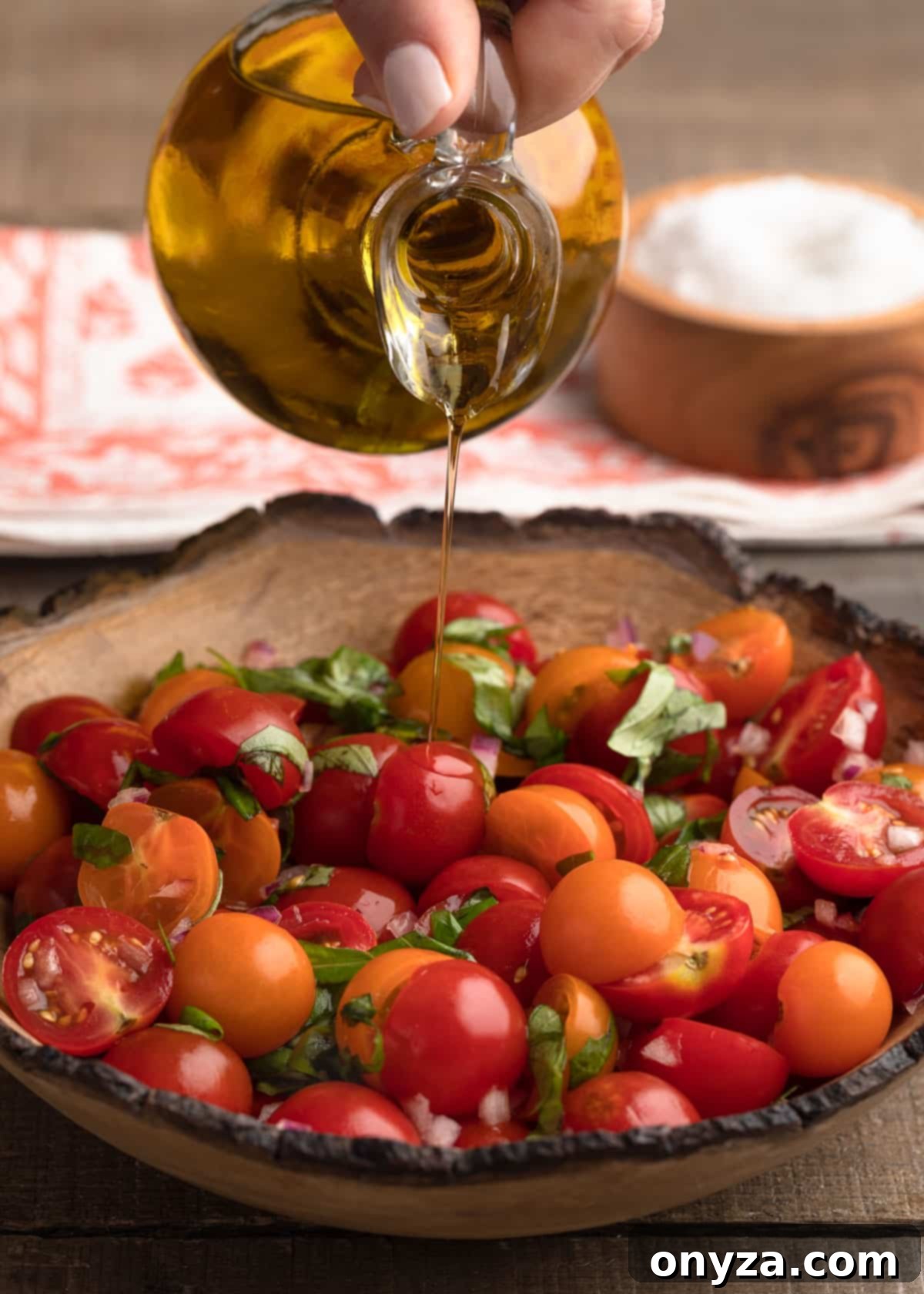 Fresh Cherry Tomato Bruschetta 5 pouring olive oil into a bowl of cherry tomato bruschetta topping