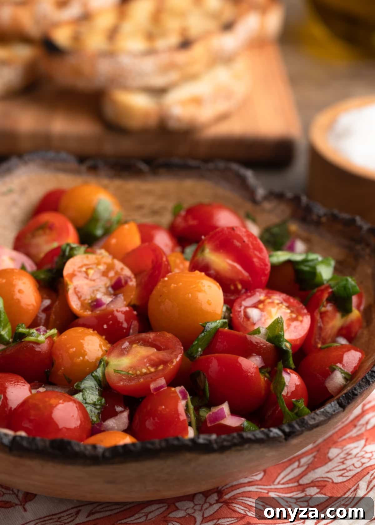 Fresh Cherry Tomato Bruschetta 6 closeup of a wood bowl of cherry tomato bruschetta topping