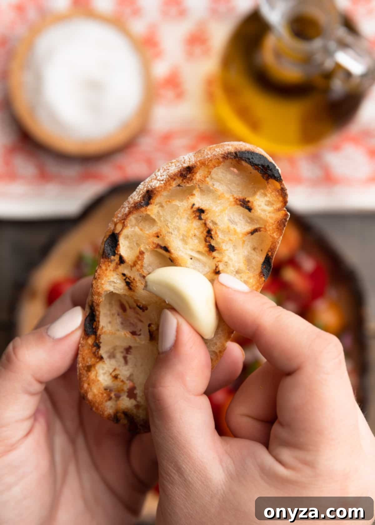 Fresh Cherry Tomato Bruschetta 8 rubbing a raw garlic clove onto a grilled slice of ciabatta