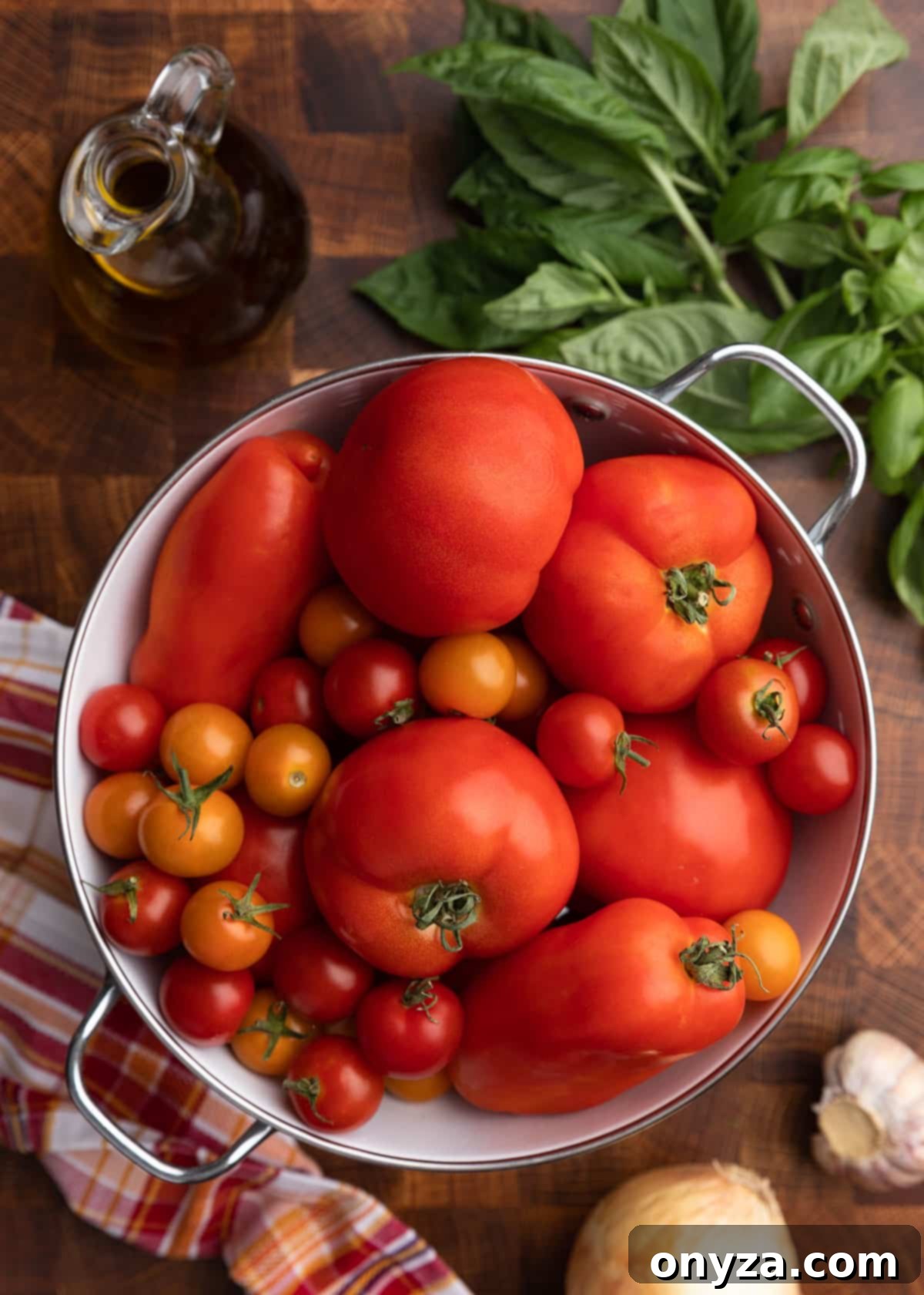 overhead photo of assorted tomatoes in a colander
