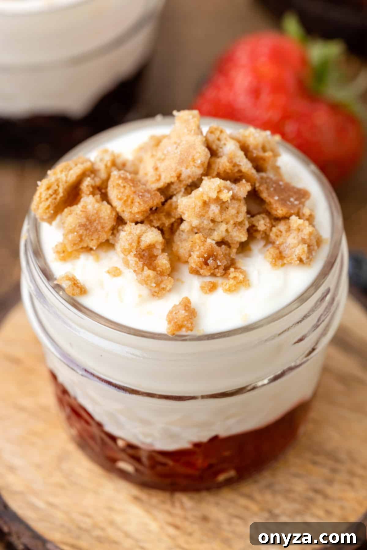 No-Bake Graham Cheesecake Delights 7 A close-up shot of a no-bake cheesecake dessert, featuring creamy layers and graham crumbles, presented in an elegant glass jar.