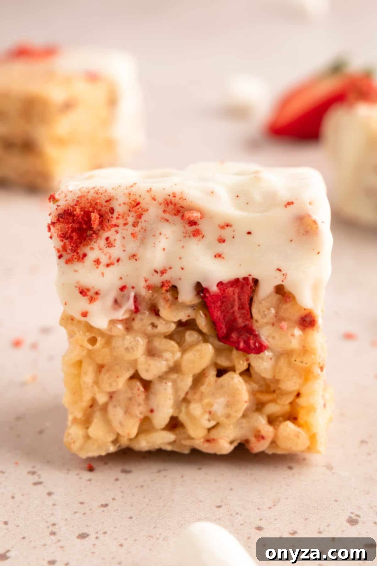 Sweet Strawberry Krispie Delights 12 Close-up shot of a Strawberry Rice Krispie Treat elegantly dipped in white chocolate, highlighting its vibrant texture