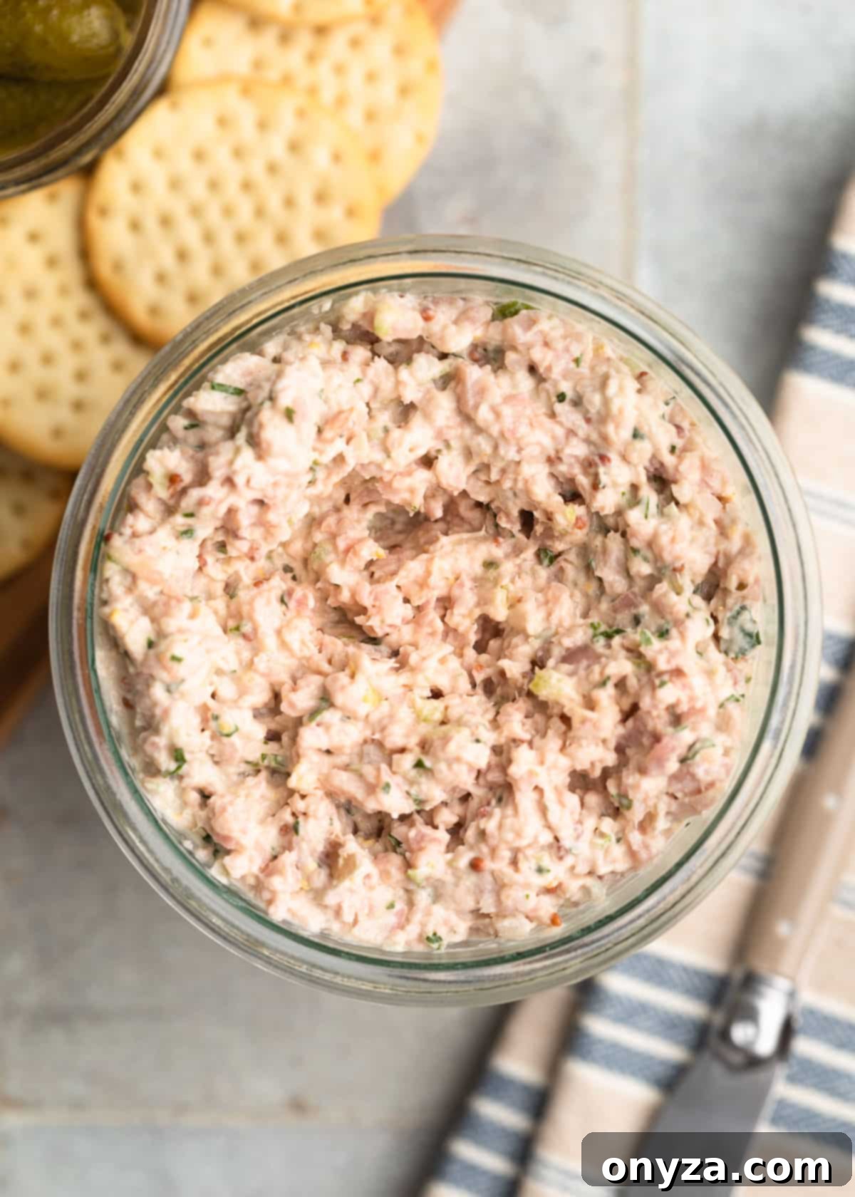 Overhead photo of homemade Deviled Ham spread in a beautiful glass jar, highlighting its fresh and creamy texture.