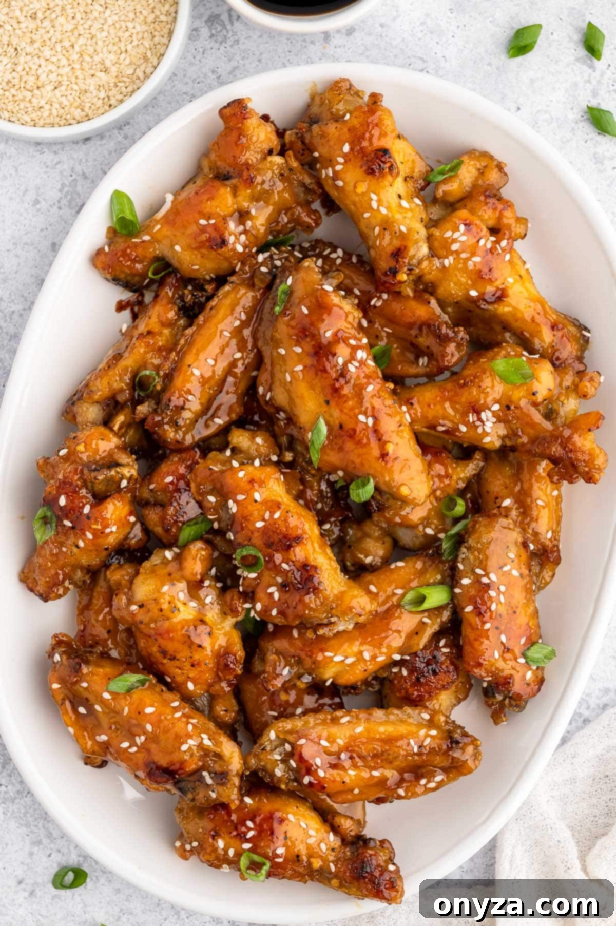 baked honey garlic chicken wings on a white platter