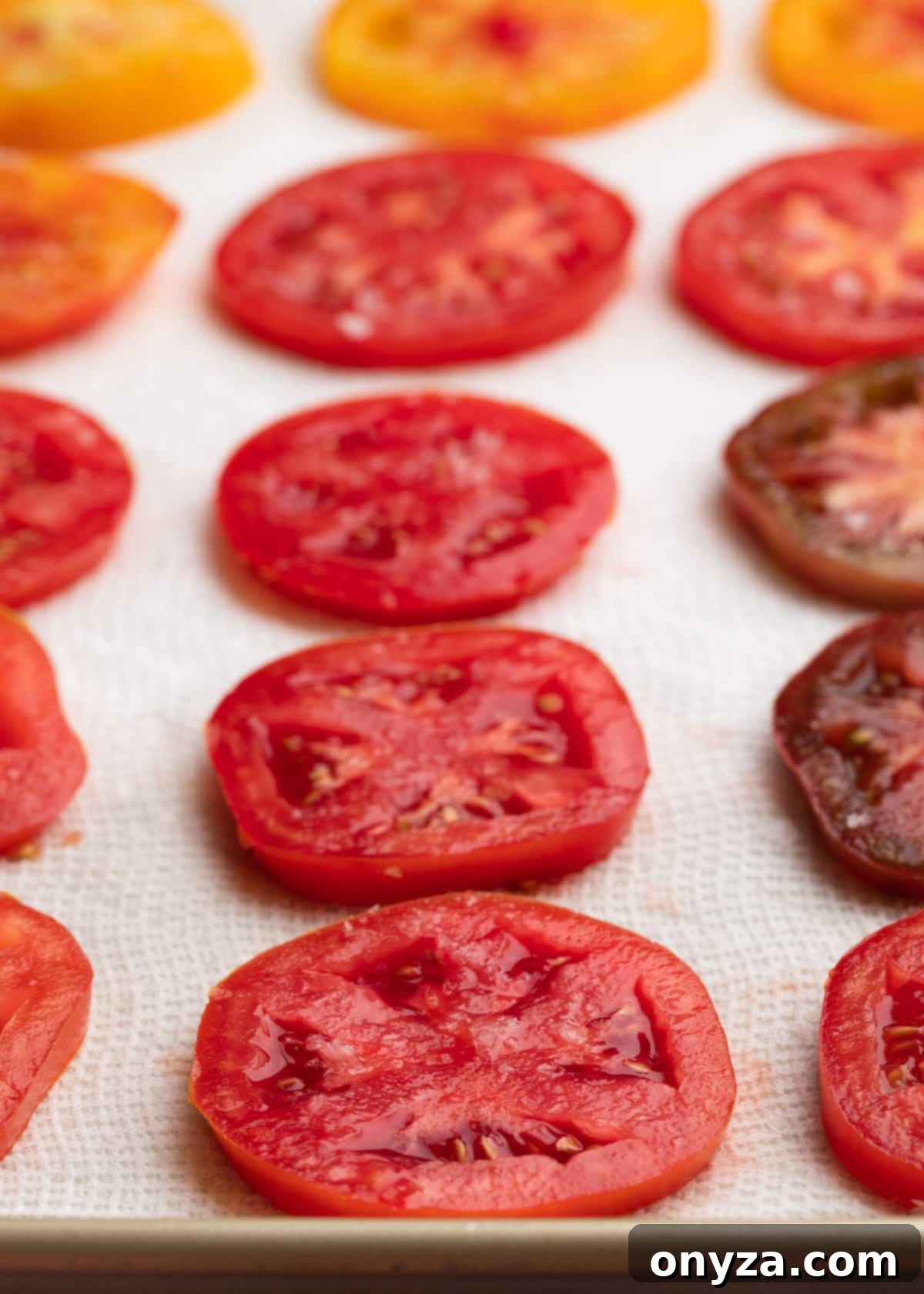 Flaky Tomato Tart 4 sliced tomatoes on a paper towel-lined baking sheet sprinkled with salt