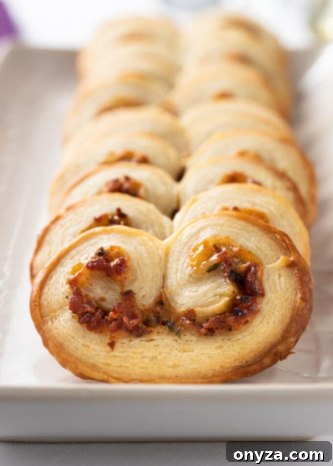 closeup of savory palmiers with bacon on a white serving platter