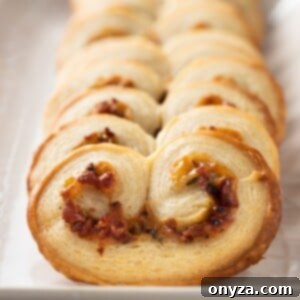closeup of savory palmiers with bacon on a white serving platter
