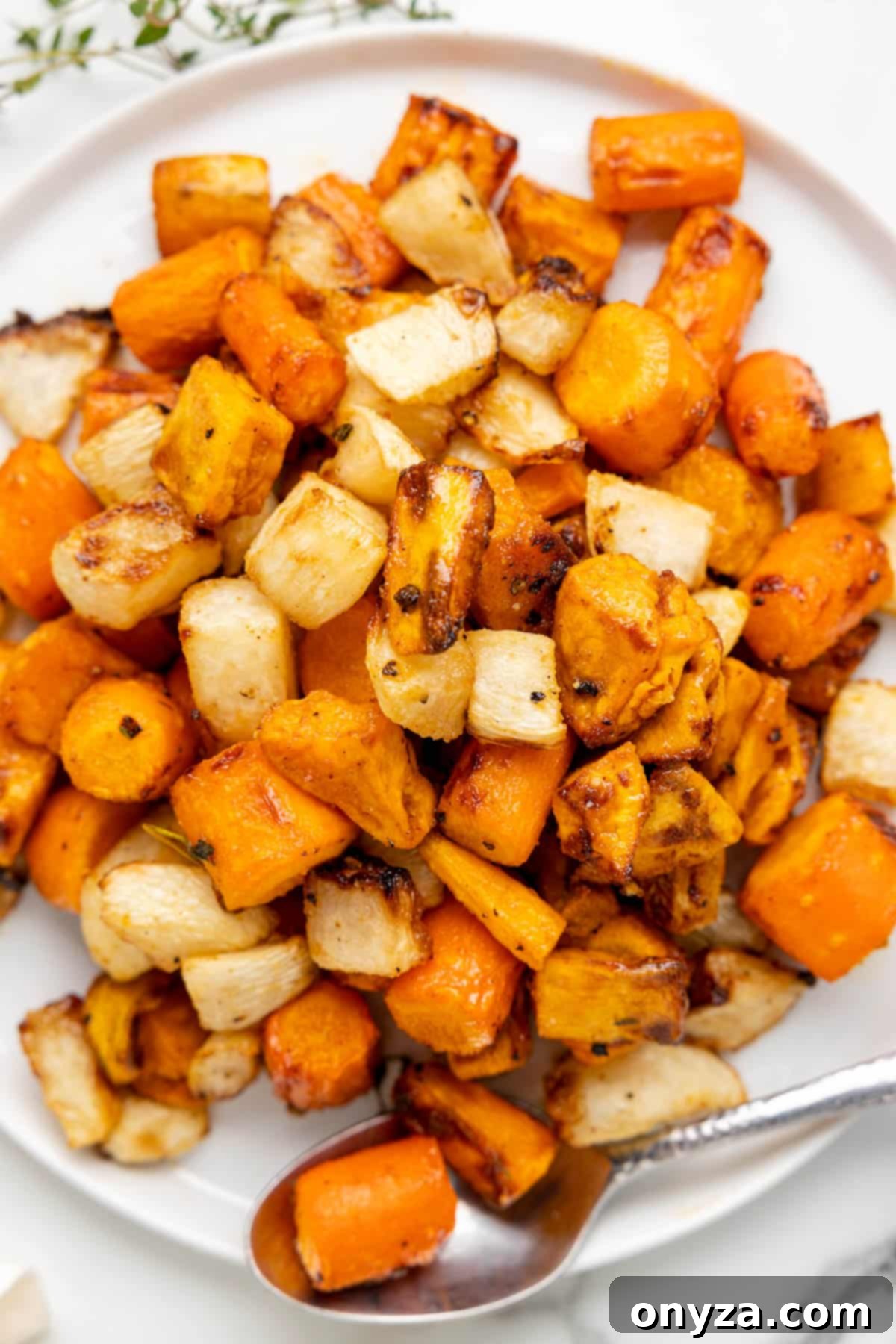 overhead photo of air fried maple glazed root vegetables on a white platter