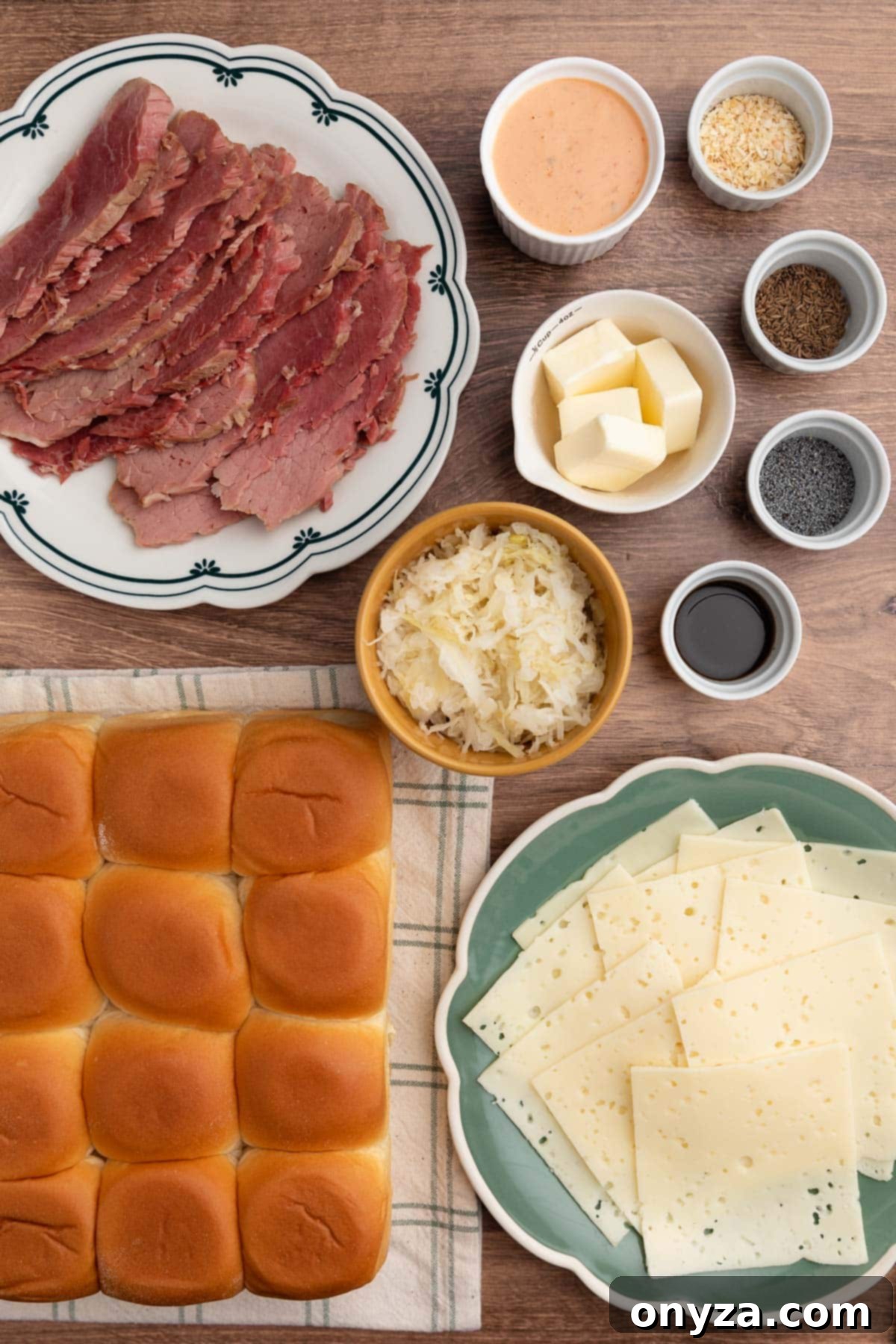overhead photo of ingredients needed to make Reuben sliders on a wooden board