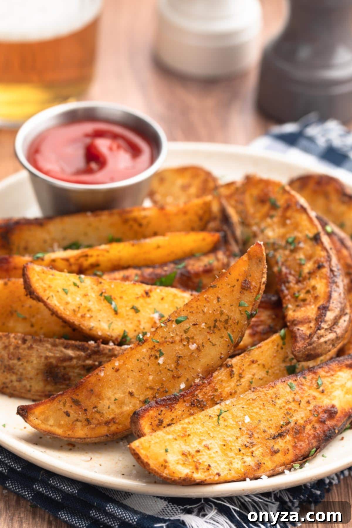 air fried seasoned potato wedges on an ivory speckled plate with a condiment cup of ketchup