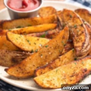 air fried seasoned potato wedges on an ivory speckled plate with a condiment cup of ketchup