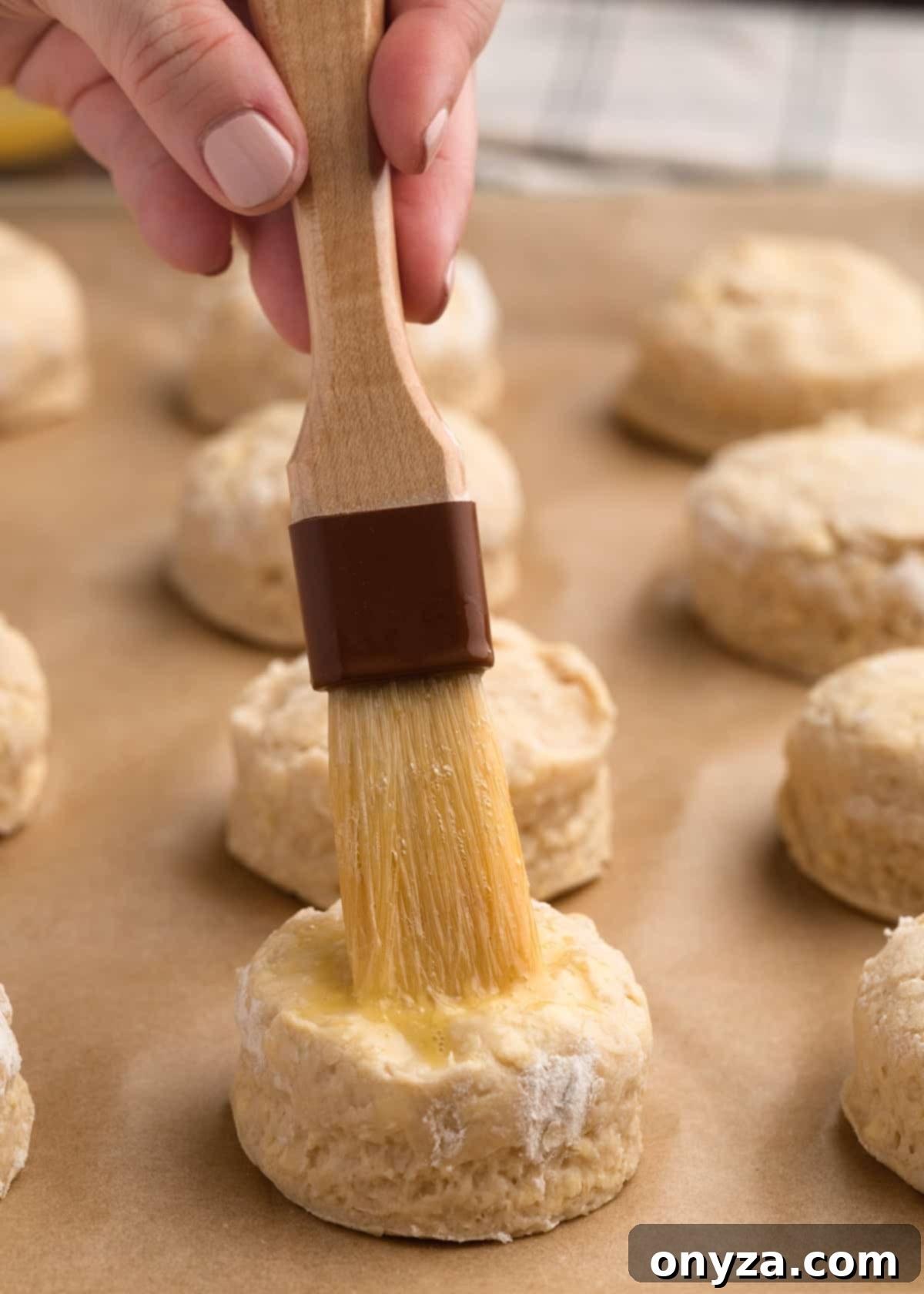 brushing cut Irish scones with egg wash from a pastry brush