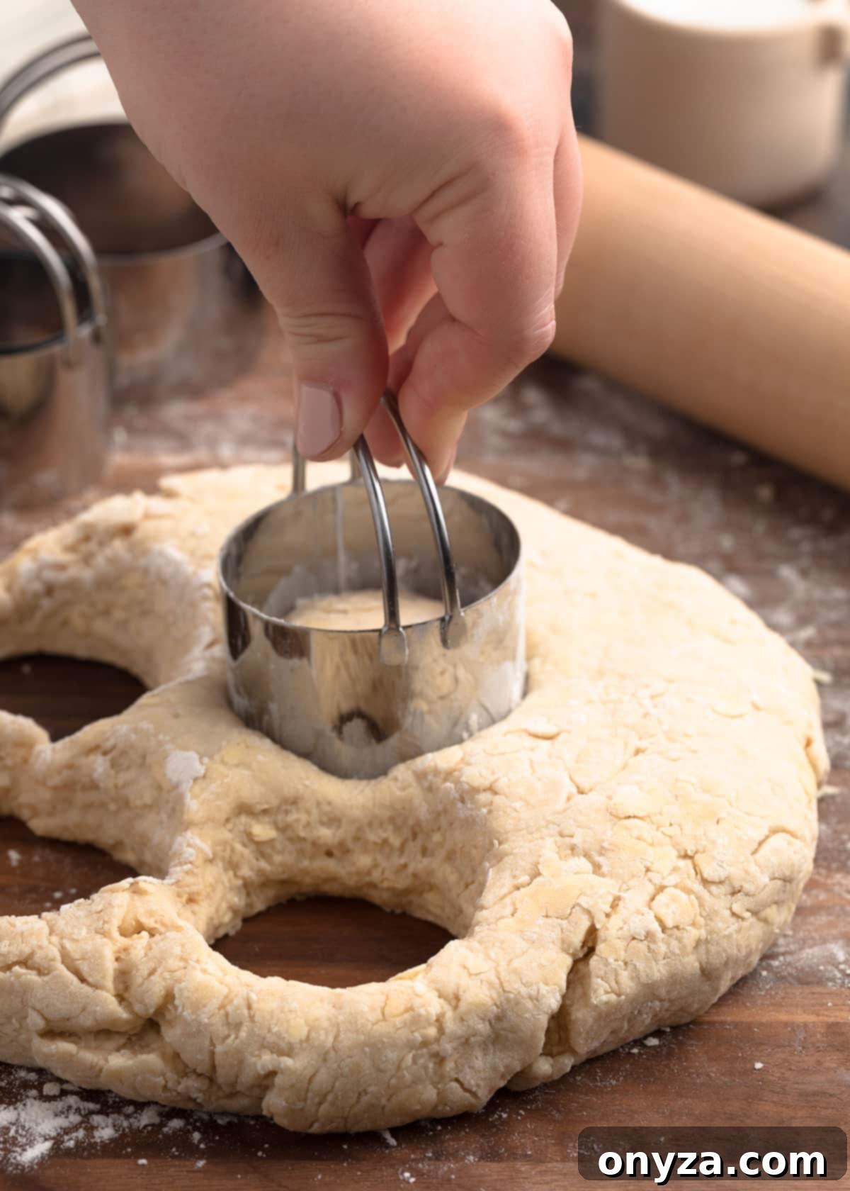 cutting rolled Irish scone dough with a stainless steel biscuit cutter