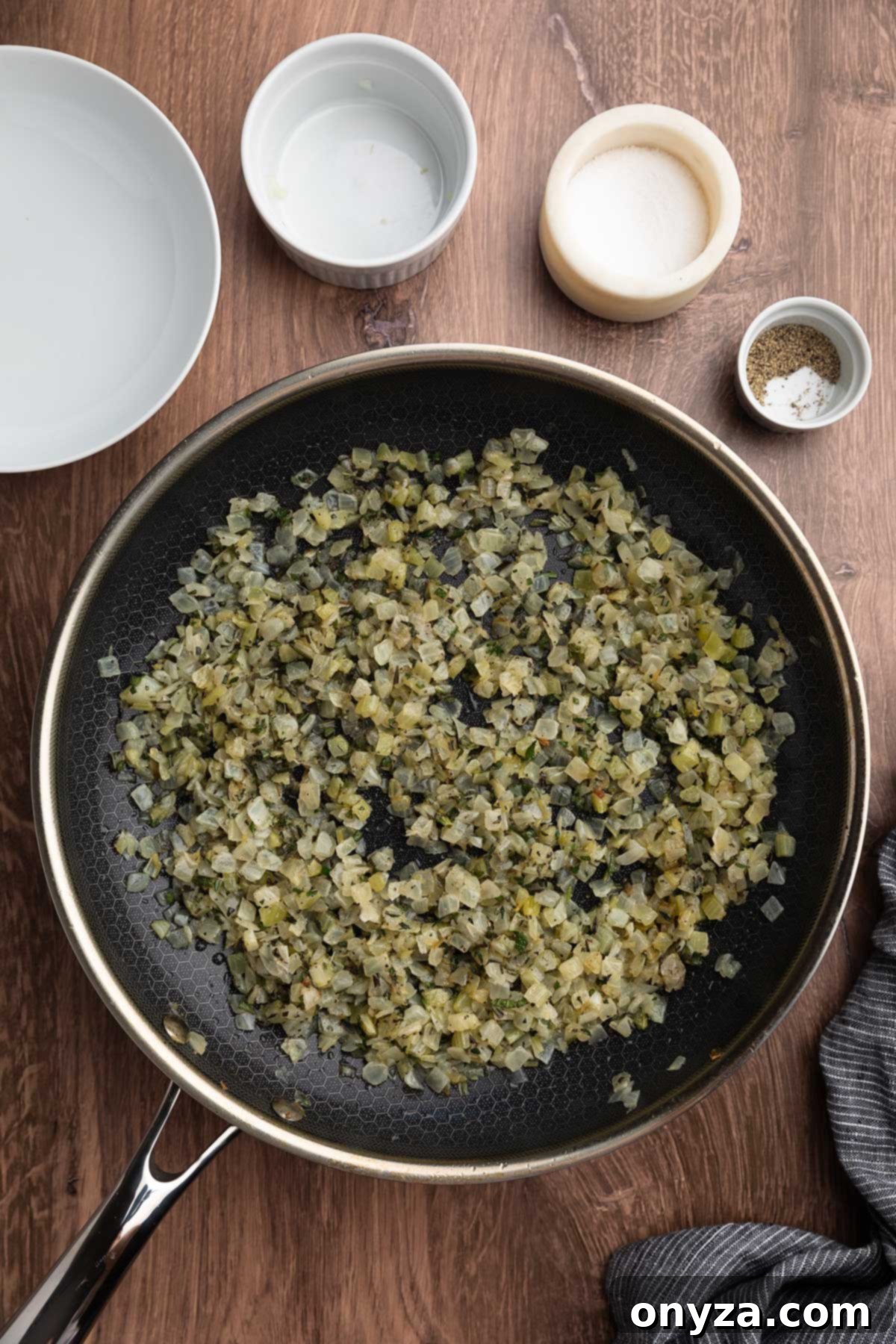 Festive Sausage and Chestnut Stuffing 11 overhead of cooked diced onions and celery in a skillet with fresh herbs and seasonings.