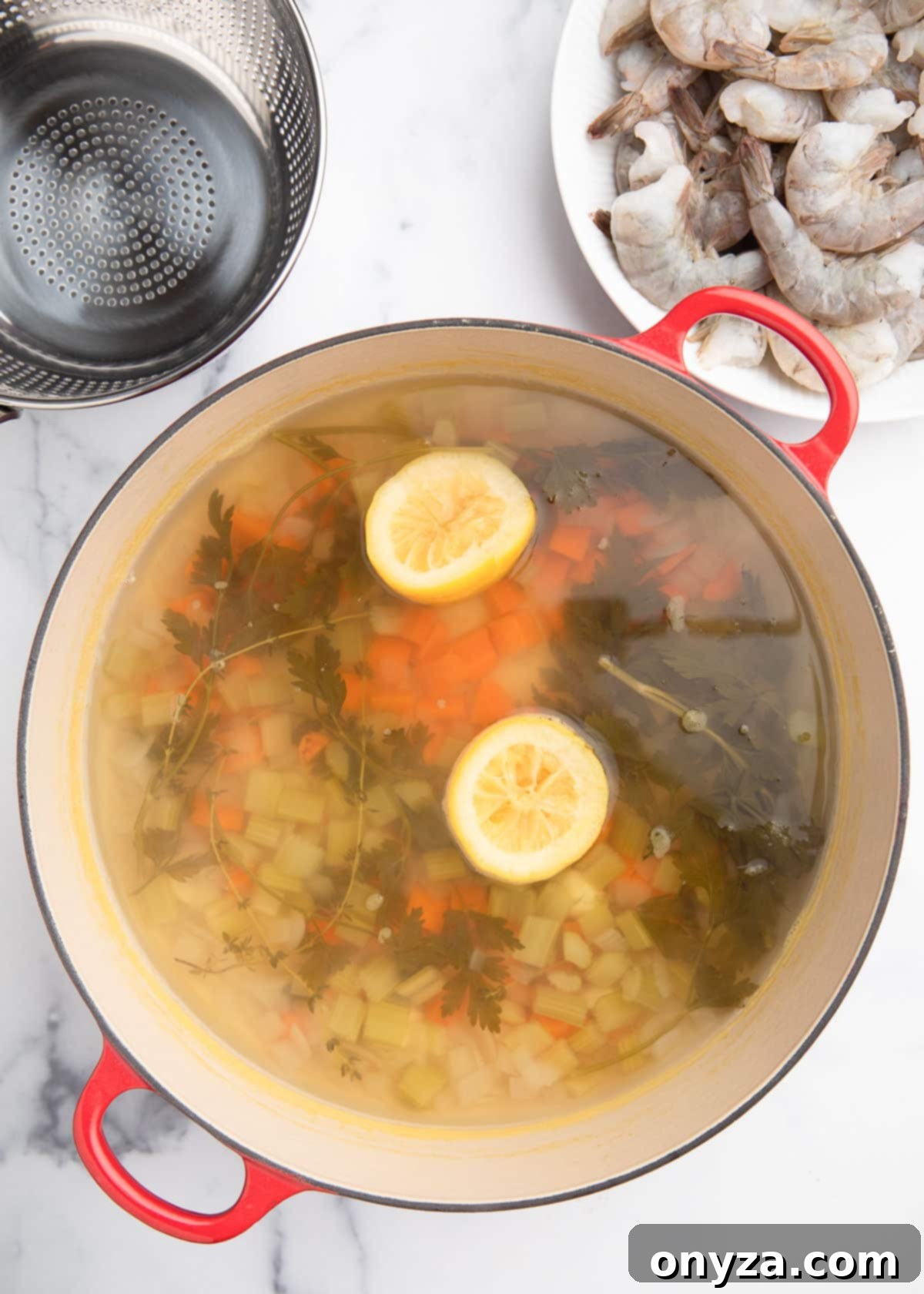 Overhead view of the simmered court bouillon in a cast iron Dutch oven, its color deepened and aromas infused after cooking.