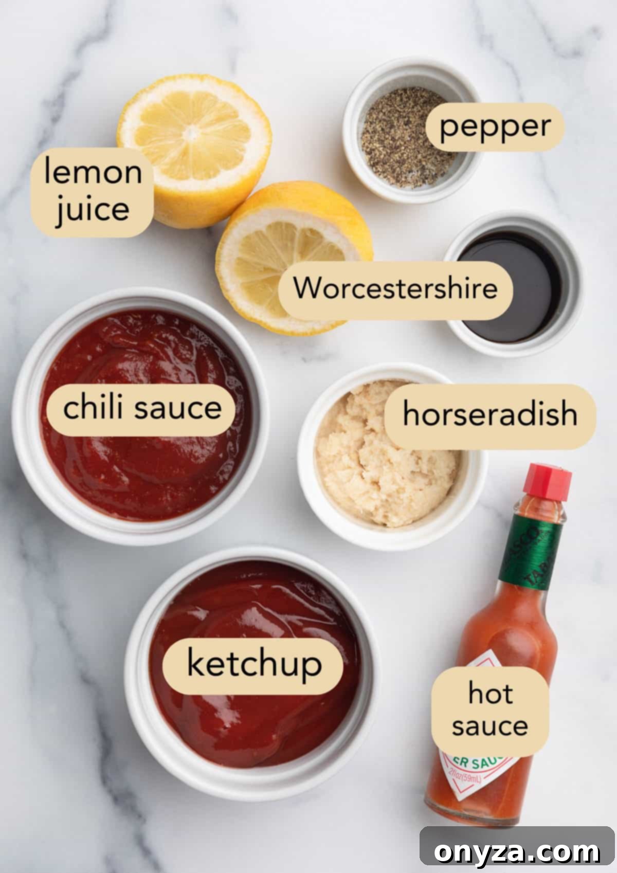 Zesty Homemade Cocktail Sauce 3 Overhead view of all ingredients for homemade cocktail sauce meticulously arranged in separate bowls, with text overlays indicating each ingredient's name: halved lemon and lemon juice, black pepper, Worcestershire sauce, prepared horseradish, hot sauce, ketchup, and chili sauce.