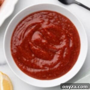 Zesty Homemade Cocktail Sauce 10 Overhead close-up of beautifully textured cocktail sauce in a pristine white bowl.