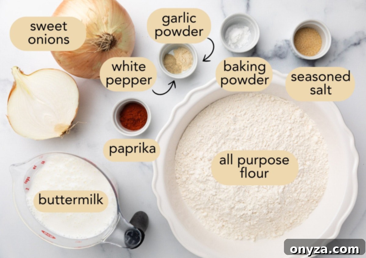A beautiful arrangement of all the essential ingredients for homemade French fried onions on a pristine marble surface. This includes whole and halved sweet onions, a bowl of creamy buttermilk, a measuring cup of all-purpose flour, and small dishes of vibrant paprika, ground white pepper, garlic powder, baking powder, and seasoned salt, all ready for preparation.
