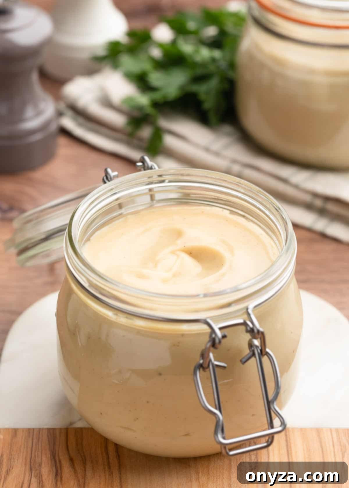 homemade condensed cream of chicken soup in a flip-top glass jar on a wood and marble board