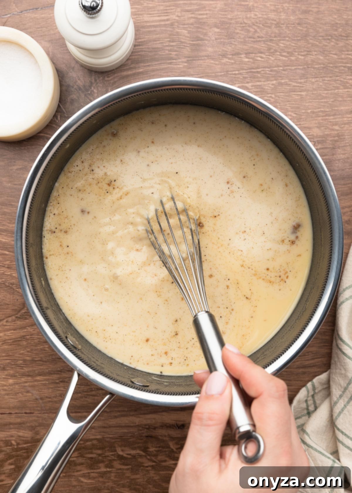 whisking ground spices into a pot of un-thickened condensed cream of chicken soup.