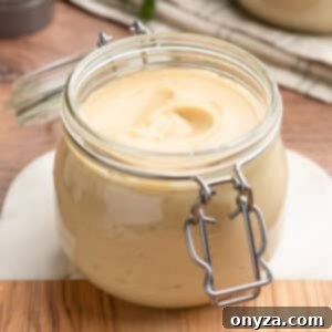 homemade condensed cream of chicken soup in a flip-top glass jar on a wood and marble board