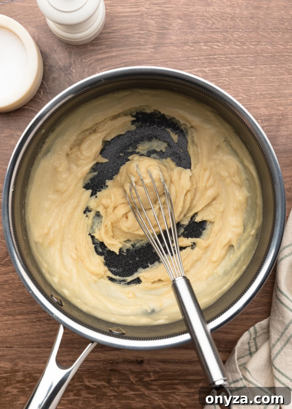 very thick homemade condensed cream of chicken soup after adding a quarter of the stock, in a pot with a whisk