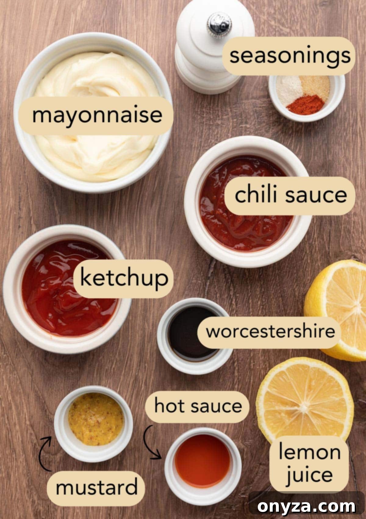 An overhead shot of various ingredients for Comeback Sauce neatly arranged in small bowls on a rustic wooden board, with descriptive text labels.