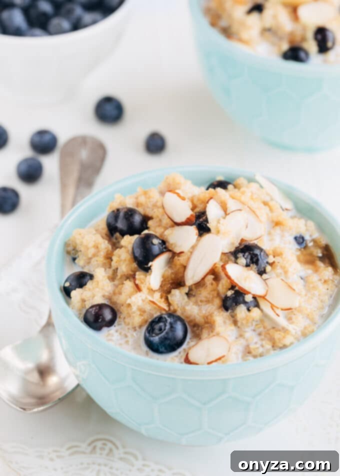 A bowl of hearty blueberry breakfast quinoa with sliced almonds, ready to be enjoyed.