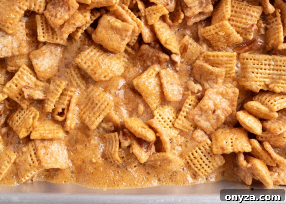 A captivating close-up shot capturing the dynamic transformation of the cereal mixture during baking, where the rich cinnamon praline glaze is actively bubbling and caramelizing, showcasing the intricate texture of the sticky, sweet coating as it sets.