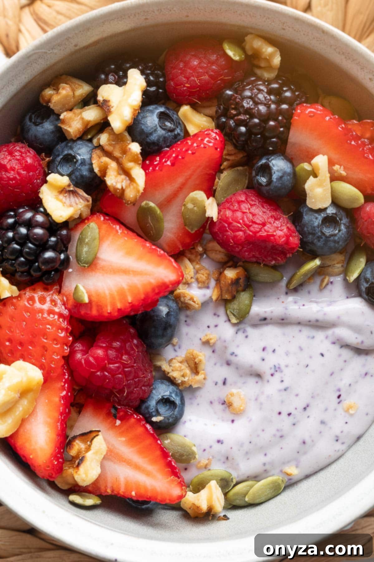 Blueberry Protein Smoothie Bowls 2 A beautifully presented blueberry blended cottage cheese smoothie bowl, topped with mixed pepitas, pumpkin seeds, and toasted walnuts, ready to be enjoyed.